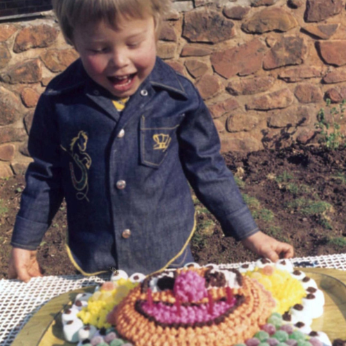 Young Elon Musk celebrating birthday with cake